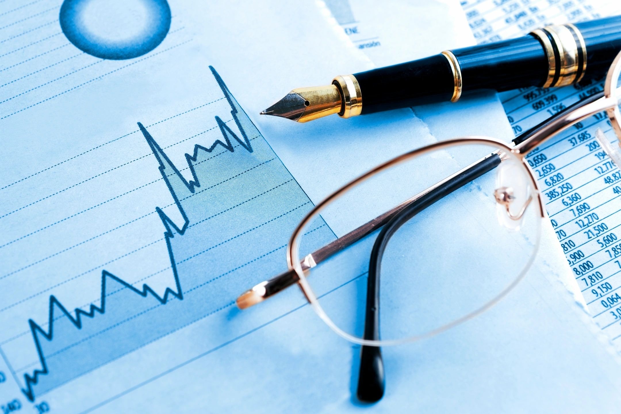 Financial analysis documents and charts on a professional desk